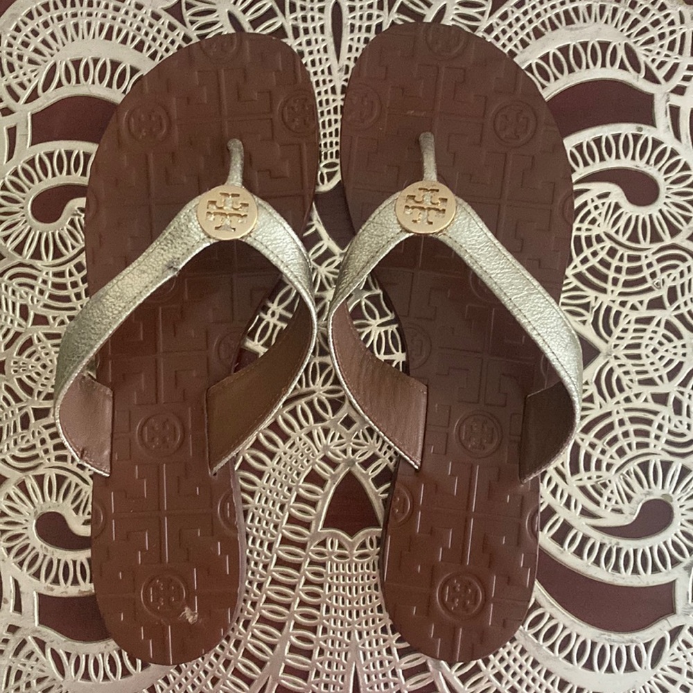 Tory Burch leather flip flops with gold straps. Size 7M.